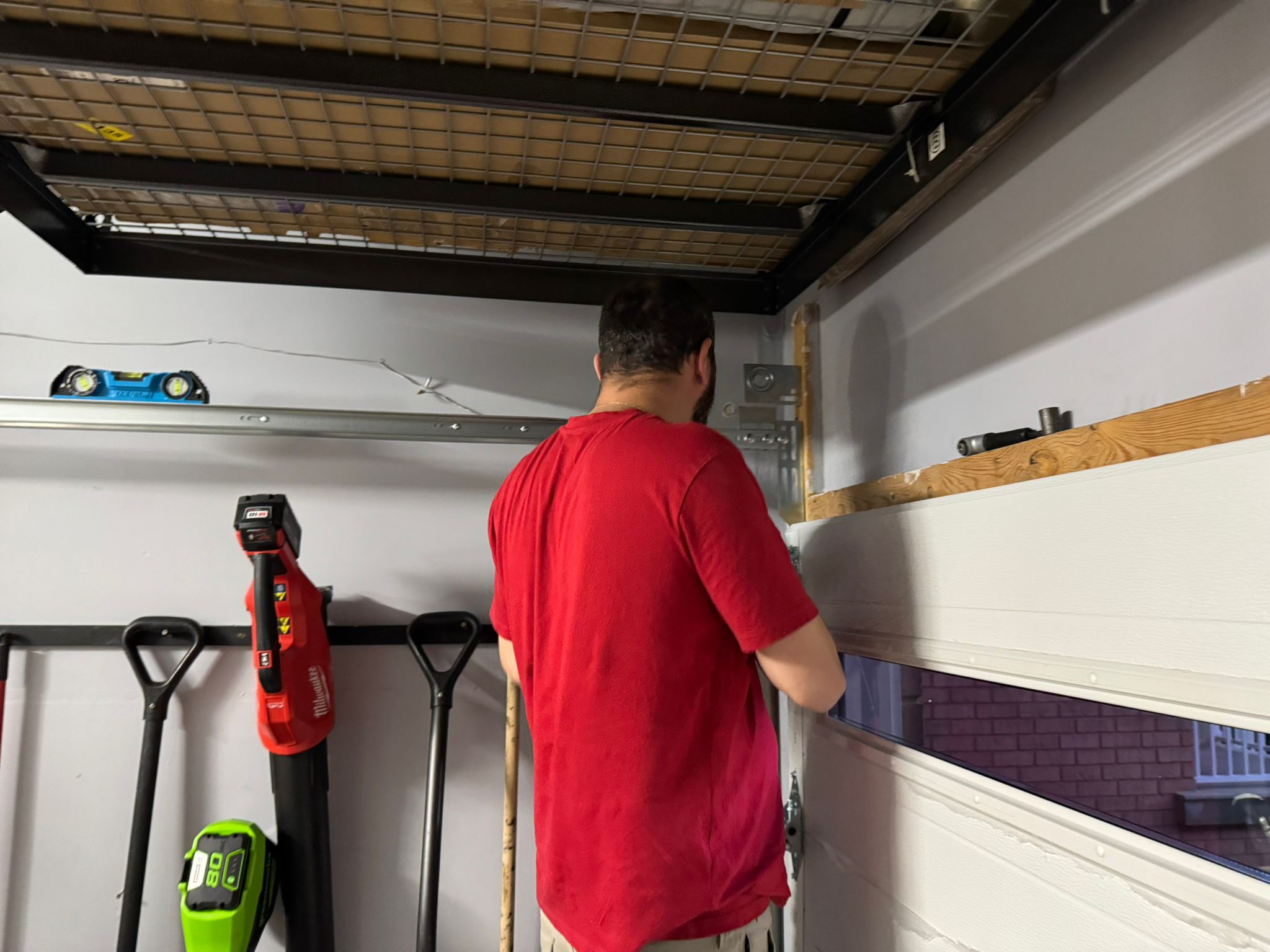 Jacob working on a garage door panel